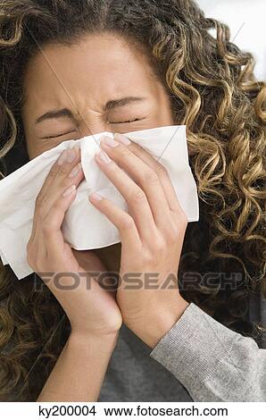 Close-up of a girl blowing nose View Large Photo Image Picture - Close-up of a girl blowing nose. Fotosearch
