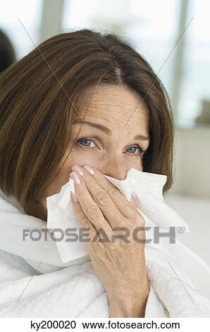 Close-up of a woman blowing nose View Large Photo Image Stock Image - Close-up of a woman blowing nose. Fotosearch