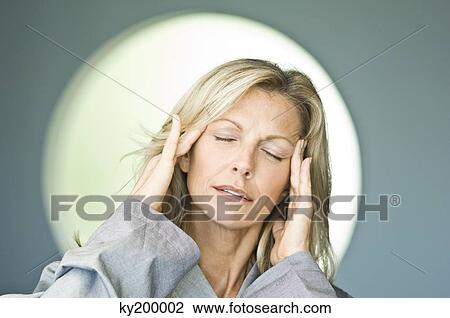 Close-up of a woman holding her head View Large Photo Image Stock Image - Close-up of a woman holding her head. Fotosearch