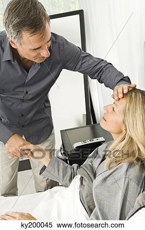 Man assisting his ill wife View Large Photo Image Stock Photography - Man assisting his ill wife. Fotosearch