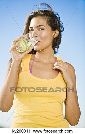Portrait of a woman drinking lemonade View Large Photo Image Stock Image - Portrait of a woman drinking lemonade. Fotosearch