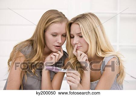 Two women looking at a pregnancy test stick View Large Photo Image Stock Image - Two women looking at a pregnancy test stick. Fotosearch