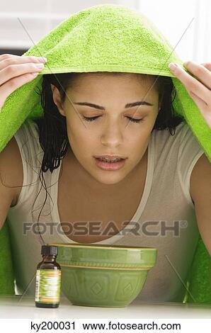 Woman inhaling over a bowl View Large Photo Image Stock Image - Woman inhaling over a bowl. Fotosearch