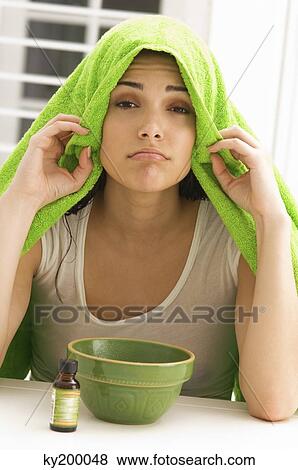 Woman inhaling over a bowl View Large Photo Image Stock Photo - Woman inhaling over a bowl. Fotosearch