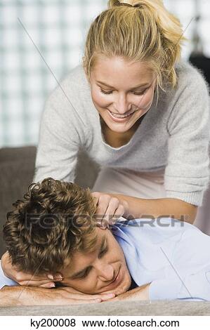 Woman rubbing temples of a man View Large Photo Image Stock Photo - Woman rubbing temples of a man. Fotosearch