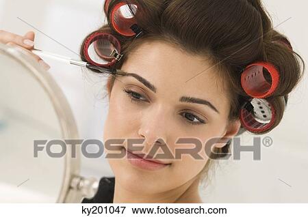 Close-up of a woman tweezing eyebrows View Large Photo Image Stock Photo - Close-up of a woman tweezing eyebrows. Fotosearch