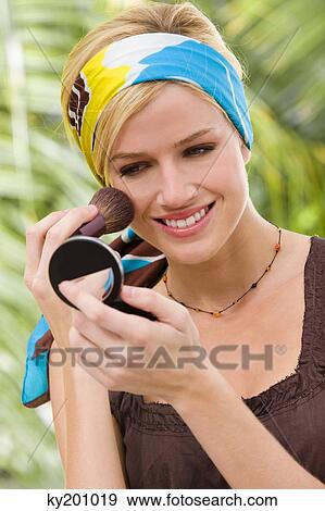 Woman applying blusher View Large Photo Image Stock Photo - Woman applying blusher. Fotosearch