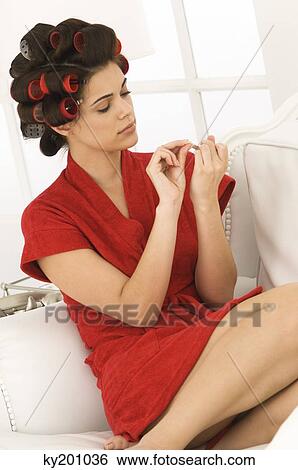 Woman filing nails with a nail file View Large Photo Image Stock Photograph - Woman filing nails with a nail file. Fotosearch