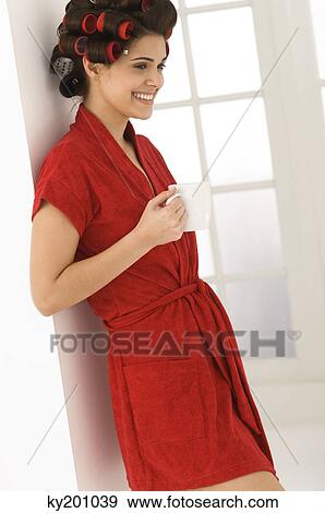 Woman holding a coffee cup and smiling View Large Photo Image Stock Photo - Woman holding a coffee cup and smiling. Fotosearch