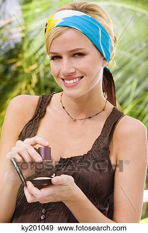 Stock Photo - Woman holding powder compact. Fotosearch