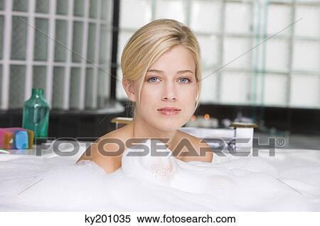 Stock Photography - Woman taking a bubble bath. Fotosearch