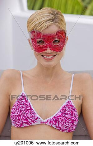 Woman wearing an eye mask View Large Photo Image Stock Photograph - Woman wearing an eye mask. Fotosearch
