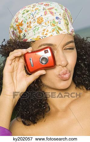 Close-up of a woman taking a picture with a digital camera View Large Photo Image Stock Photo - Close-up of a woman taking a picture with a digital camera. Fotosearch