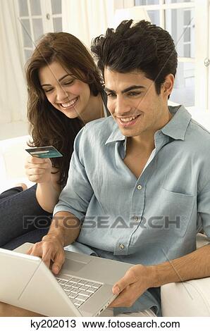 Couple shopping online with a credit card View Large Photo Image Stock Image - Couple shopping online with a credit card. Fotosearch