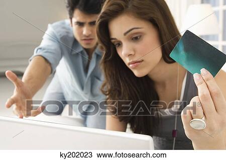 Couple shopping online with a credit card View Large Photo Image Stock Image - Couple shopping online with a credit card. Fotosearch