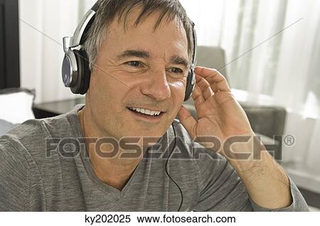 Man listening to music with headphones View Large Photo Image Stock Photography - Man listening to music with headphones. Fotosearch