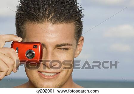 Man taking a picture with a digital camera View Large Photo Image Stock Image - Man taking a picture with a digital camera. Fotosearch