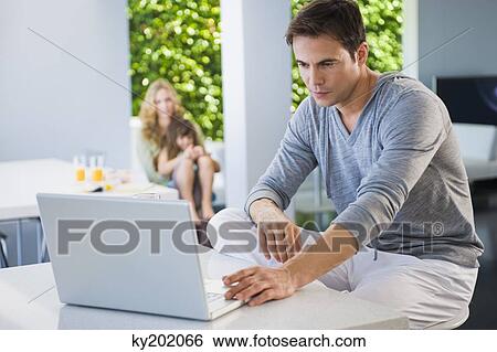 Man working on a laptop View Large Photo Image Stock Photograph - Man working on a laptop. Fotosearch
