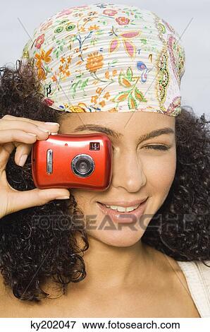 Woman taking a picture with a digital camera View Large Photo Image Stock Photo - Woman taking a picture with a digital camera. Fotosearch