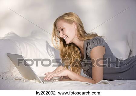 Woman using a laptop View Large Photo Image Stock Image - Woman using a laptop. Fotosearch