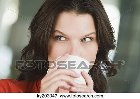 Close-up of a woman drinking tea View Large Photo Image Stock Photo - Close-up of a woman drinking tea. Fotosearch