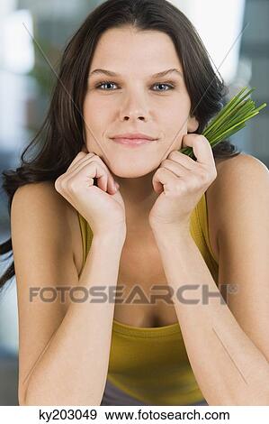 Portrait of a woman holding chives View Large Photo Image Stock Photo - Portrait of a woman holding chives. Fotosearch