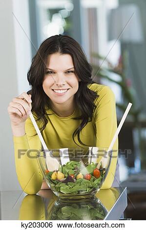 Portrait of a woman mixing salad View Large Photo Image Stock Photograph - Portrait of a woman mixing salad. Fotosearch