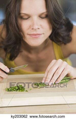 Woman chopping chives View Large Photo Image Stock Image - Woman chopping chives. Fotosearch