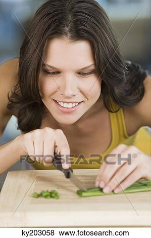 Woman chopping chives View Large Photo Image Stock Photo - Woman chopping chives. Fotosearch
