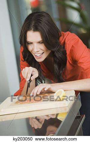 Woman cutting salmon slices View Large Photo Image Stock Image - Woman cutting salmon slices. Fotosearch