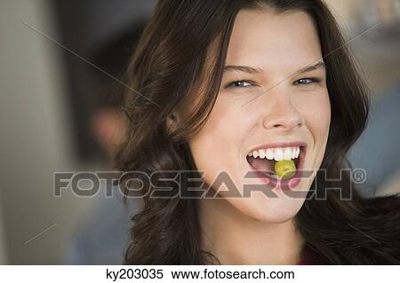 Woman eating a grape View Large Photo Image Stock Photography - Woman eating a grape. Fotosearch