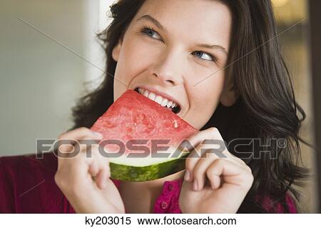 Woman eating a watermelon slice View Large Photo Image Stock Photography - Woman eating a watermelon slice. Fotosearch