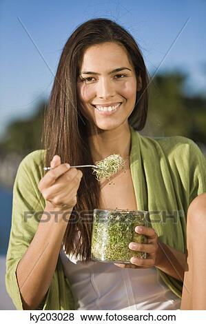 Woman eating bean sprouts View Large Photo Image Stock Photo - Woman eating bean sprouts. Fotosearch