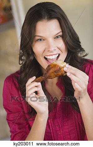 Woman eating chicken View Large Photo Image Stock Image - Woman eating chicken. Fotosearch