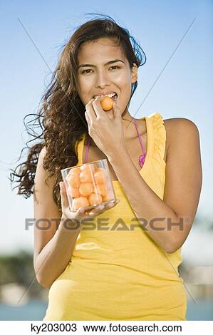 Woman eating fruits View Large Photo Image Stock Image - Woman eating fruits. Fotosearch