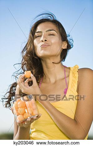 Woman eating fruits View Large Photo Image Stock Photograph - Woman eating fruits. Fotosearch