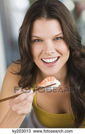 Woman eating sushi View Large Photo Image Stock Image - Woman eating sushi. Fotosearch