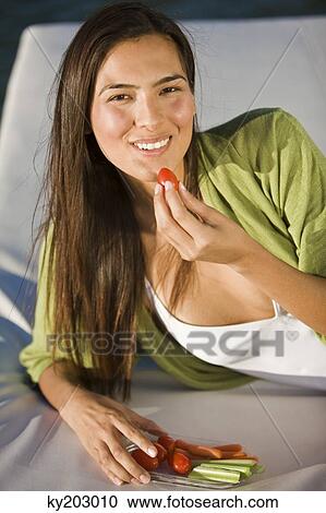 Woman eating vegetables View Large Photo Image Stock Image - Woman eating vegetables. Fotosearch
