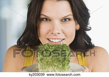 Woman holding a bunch of bean sprouts in a plate View Large Photo Image Stock Photo - Woman holding a bunch of bean sprouts in a plate. Fotosearch