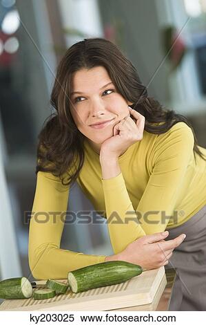 Woman leaning on a kitchen counter View Large Photo Image Stock Photography - Woman leaning on a kitchen counter. Fotosearch