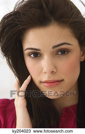 Portrait of a woman with her hand in her hair View Large Photo Image Stock Image - Portrait of a woman with her hand in her hair. Fotosearch