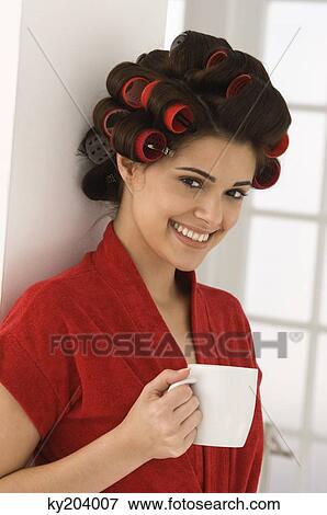 Woman holding a coffee cup and smiling View Large Photo Image Stock Photo - Woman holding a coffee cup and smiling. Fotosearch