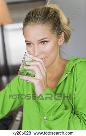 Close-up of a woman drinking water from a glass View Large Photo Image Stock Photo - Close-up of a woman drinking water from a glass. Fotosearch