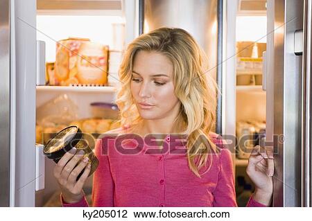 Close-up of a woman looking at a can View Large Photo Image Stock Image - Close-up of a woman looking at a can. Fotosearch