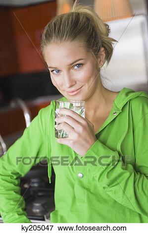 Portrait of a woman drinking water from a glass View Large Photo Image Stock Photo - Portrait of a woman drinking water from a glass. Fotosearch