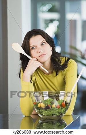 Woman thinking in the kitchen View Large Photo Image Stock Photo - Woman thinking in the kitchen. Fotosearch