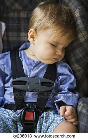 Baby boy sleeping in a baby seat View Large Photo Image Stock Image - Baby boy sleeping in a baby seat. Fotosearch