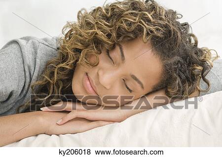 Close-up of a girl sleeping on the bed View Large Photo Image Stock Photo - Close-up of a girl sleeping on the bed. Fotosearch