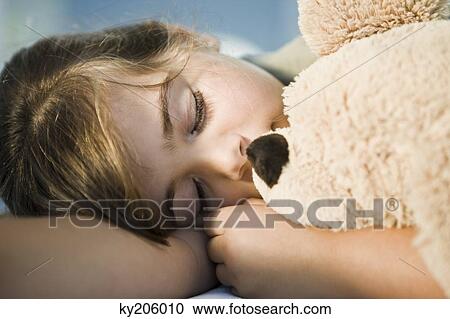 Close-up of a girl sleeping with a teddy bear View Large Photo Image Stock Image - Close-up of a girl sleeping with a teddy bear. Fotosearch