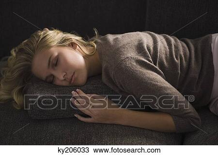 Close-up of a woman napping on a couch View Large Photo Image Stock Image - Close-up of a woman napping on a couch. Fotosearch